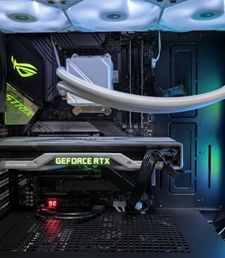 A high-end gaming or performance PC interior equipped with RGB lighting and multiple cooling fans. The graphics card prominently displayed is a GeForce RTX model, with branding visible. The setup includes neatly managed cables and a liquid cooling system.